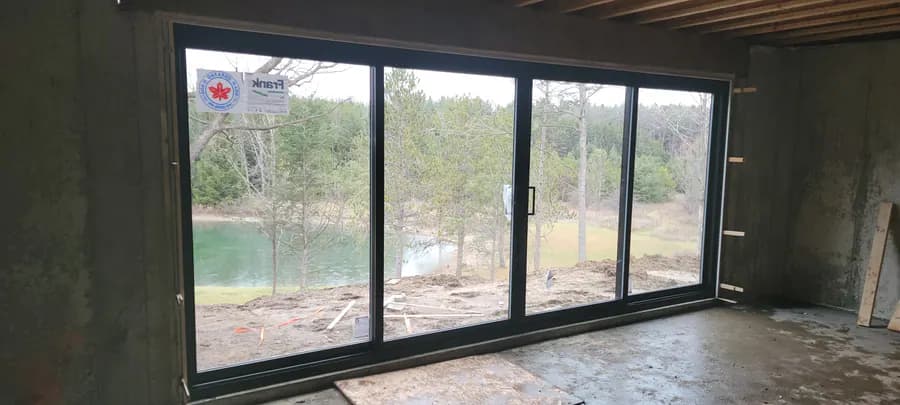 Four-panel sliding door on a new build overlooking a pond