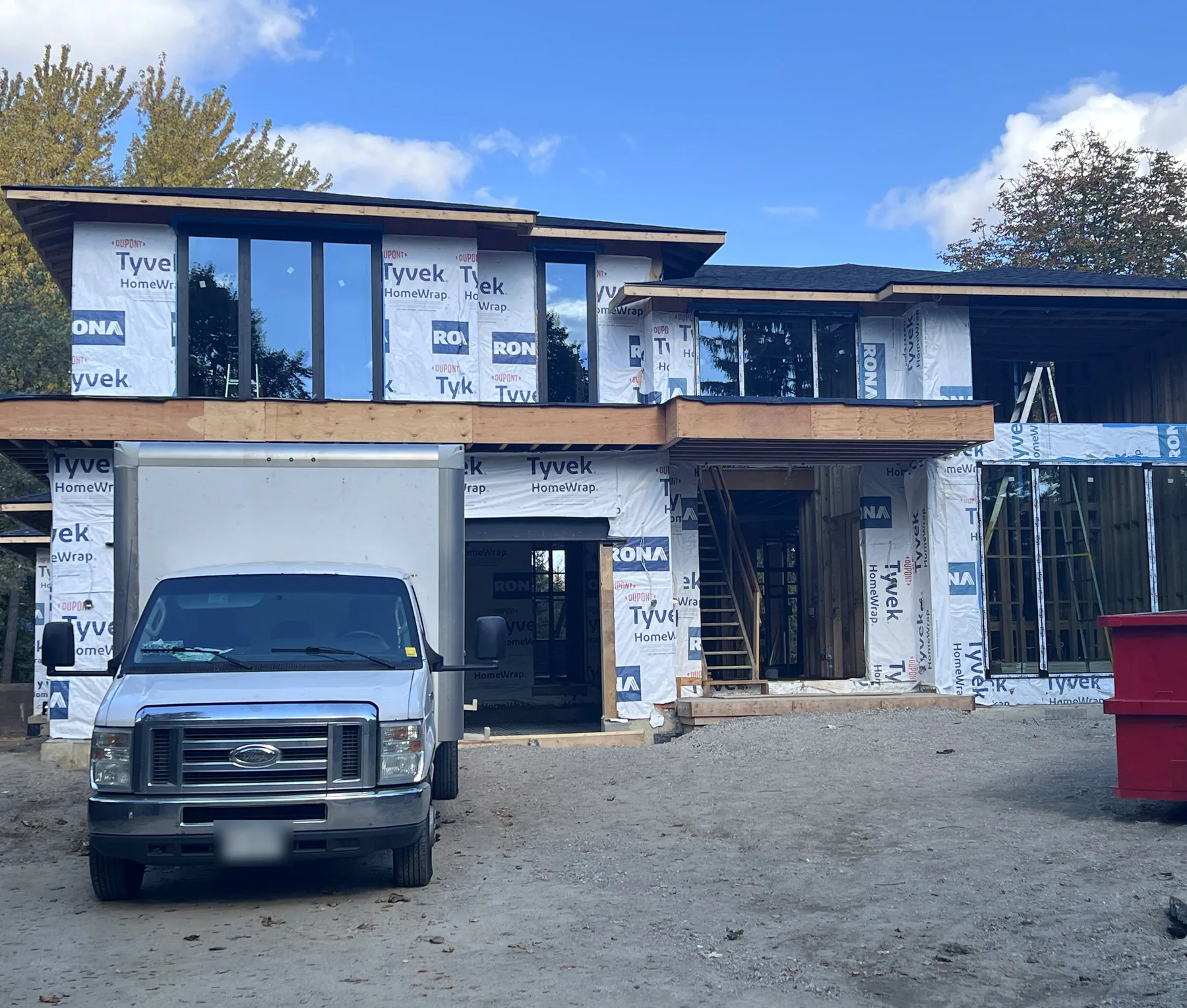 New custom home with black aluminum windows installed, still in house wrap