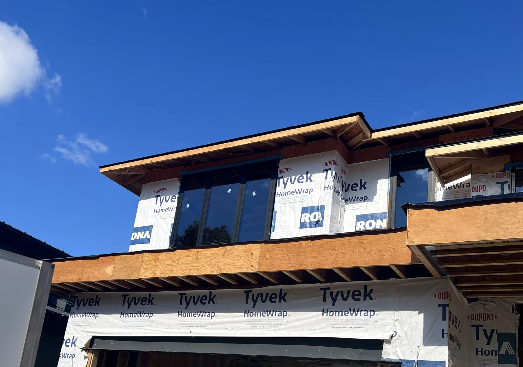 Black aluminum ribbon windows on the second floor of a new build